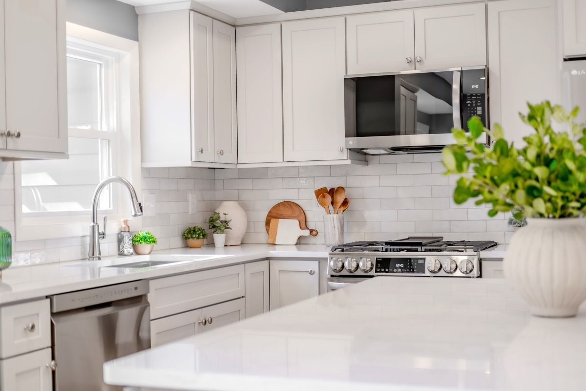 luxury kitchen remodeling project near Padgett Park Natural Area DeWitt Michigan built by Custom Built Design and Remodeling with white quartz island and subway tile backsplash