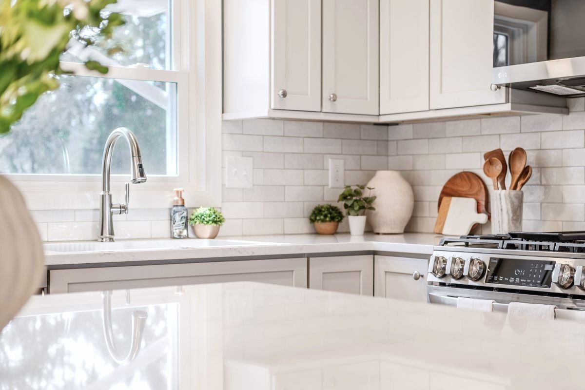 luxury kitchen remodeling project near Padgett Park Natural Area DeWitt Michigan built by Custom Built Design and Remodeling with white dura supreme cabinetry and large sink window