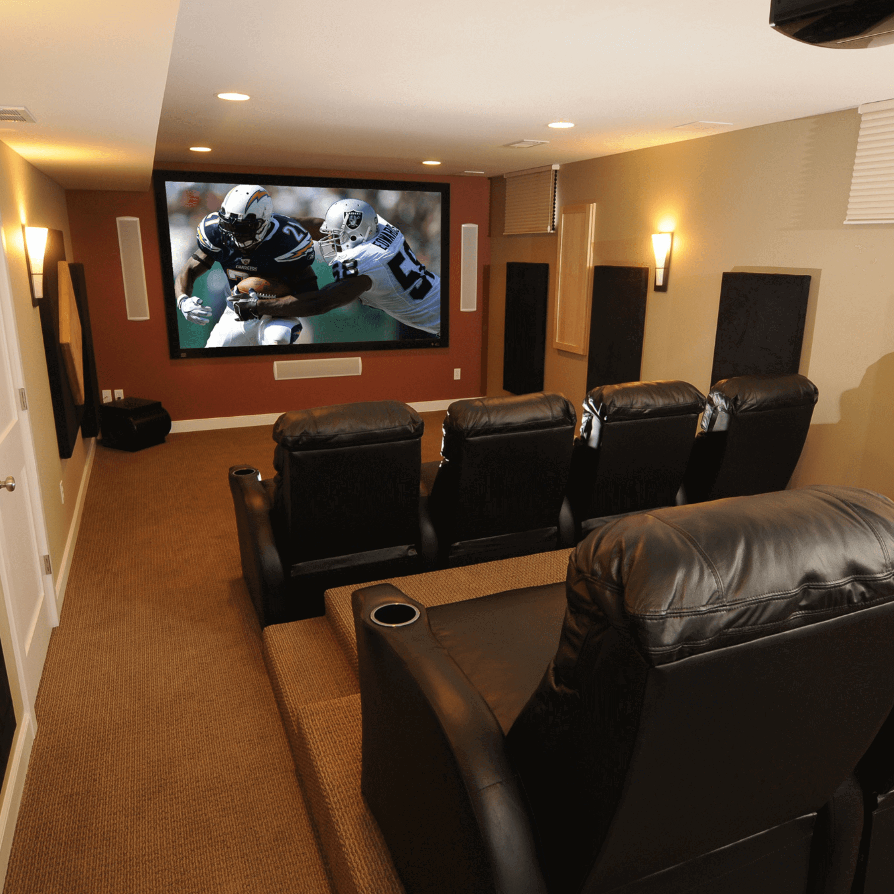 home theater with arm chairs and projector screen custom built michigan