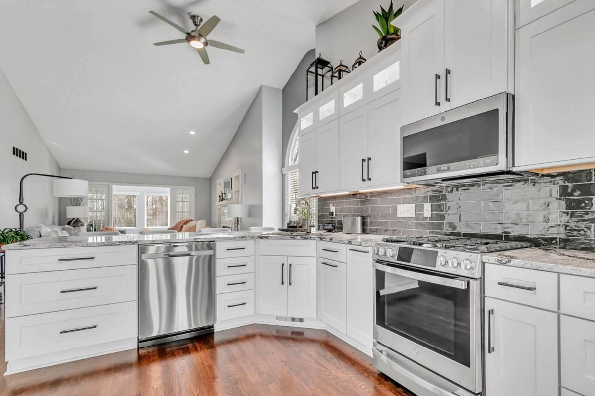kitchen remodeling project in Mason Michigan built by Custom Built Design and Remodeling with mirror tile backsplash and white cabinetry