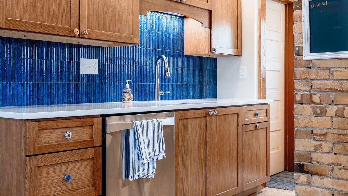 Homeowner kitchen remodel in East Lansing MI near Patriarche Park featuring blue fluted backsplash tile and custom cabinets