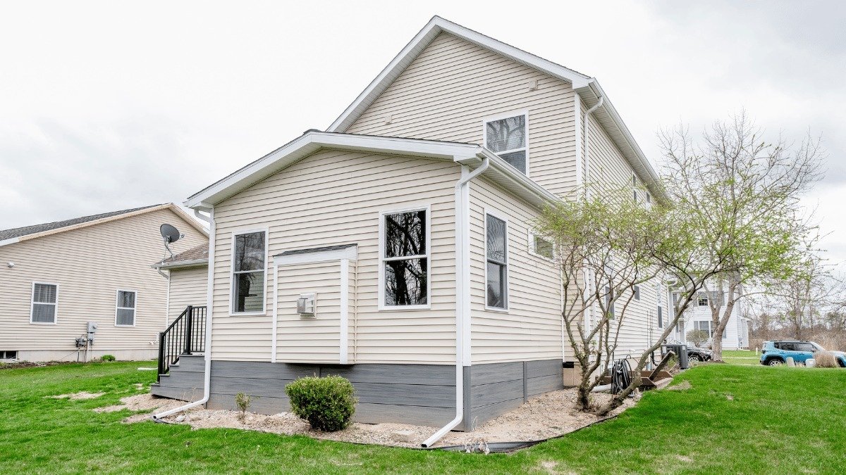 completed four seasons room addition near Kiwanis Park Holt Michigan built by Custom Built Design and Remodeling with updated siding and stairs