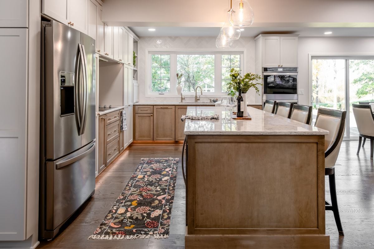 luxury kitchen remodeling project near Hartrick Park Okemos Michigan built by Custom Built and Remodeling with long quartz island and dual tone cabinetry