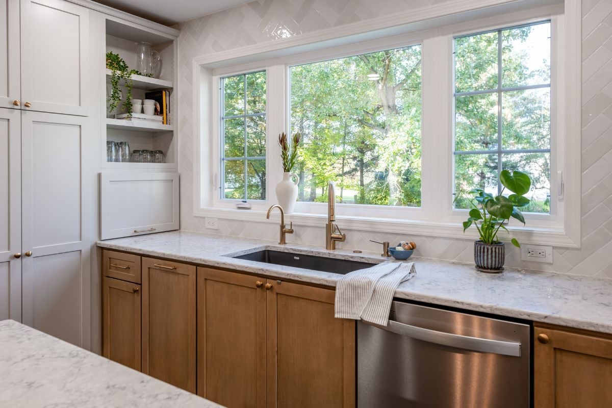 luxury kitchen remodeling project near Hartrick Park Okemos Michigan built by Custom Built and Remodeling with updated sink area and tile backsplash